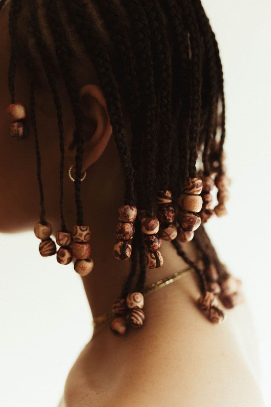 Close-up of braids finished with wooden beads